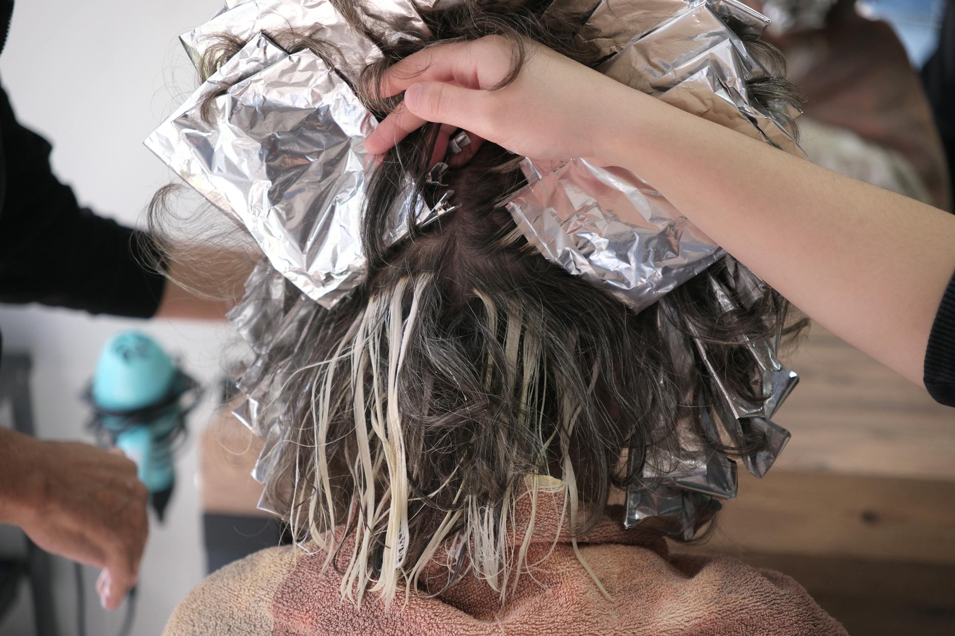 Hair coloring process with professional foils at salon